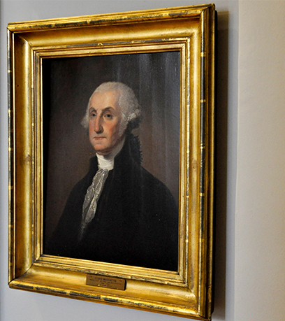 Larawan ni George Washington sa isang gintong frame.